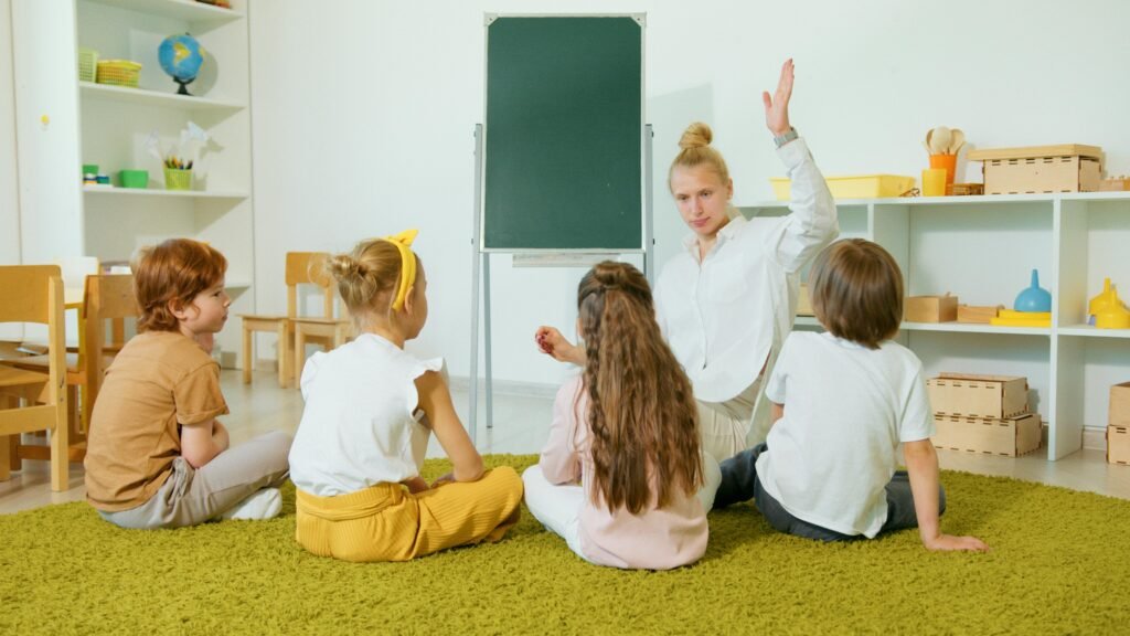 Premium CBSE Running School for Sale – Investor Opportunity Preschool teacher interacting with children in a classroom, fostering an engaging and educational environment.